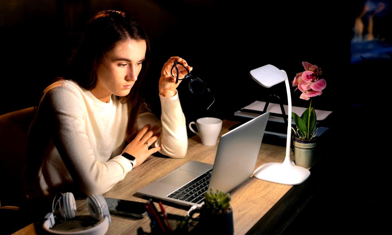 Developer working on blockchain code with multiple monitors showing smart contract architecture